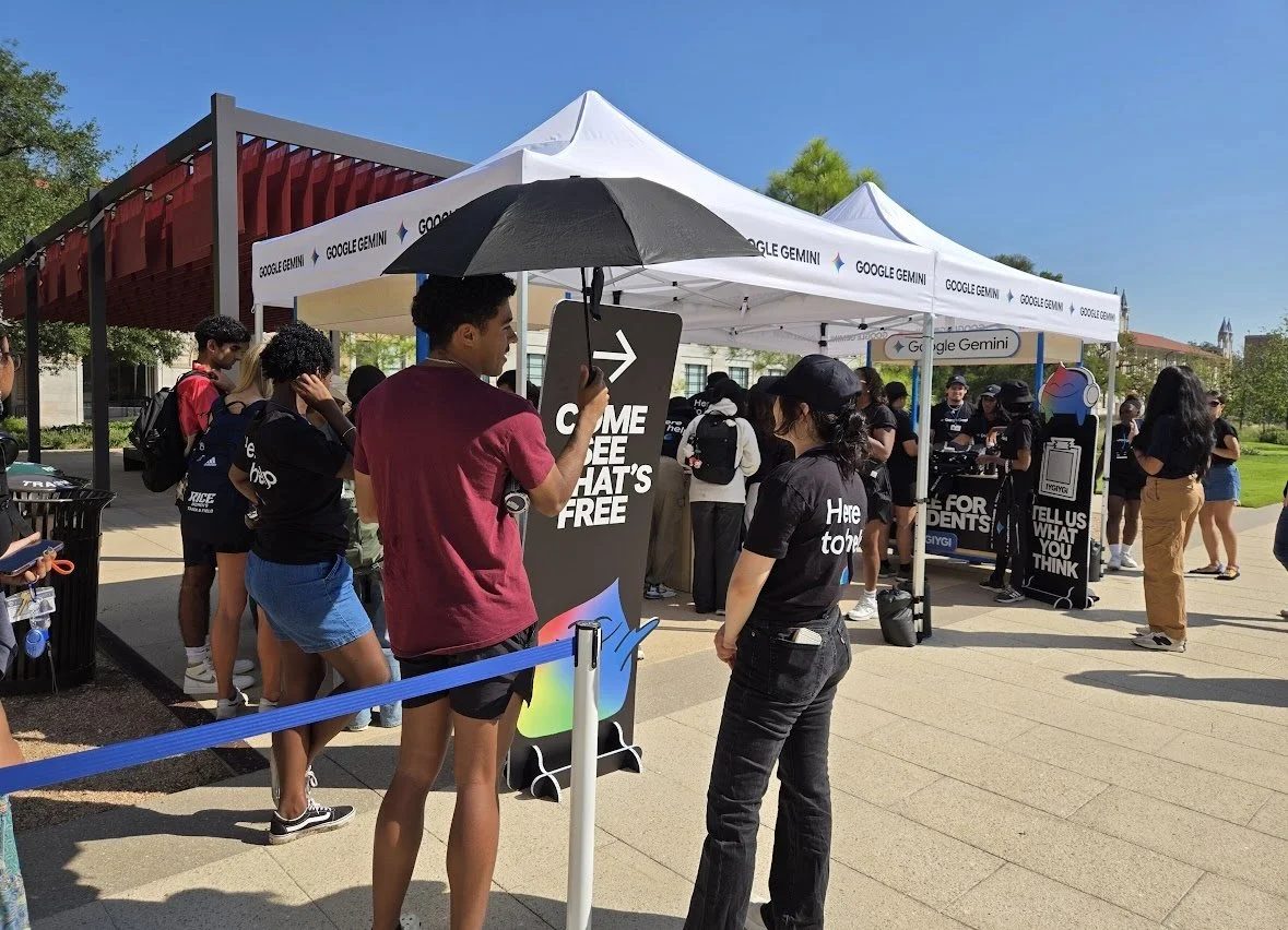 Students lining up at the Google Gemini tents on the Rice campus